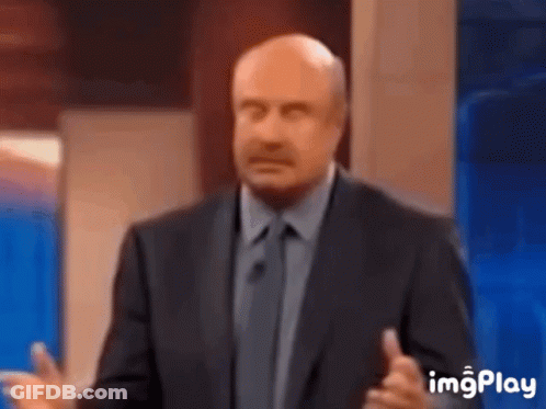 A Bald Man In A Suit And Tie Is Giving A Speech On A Television Show . GIF