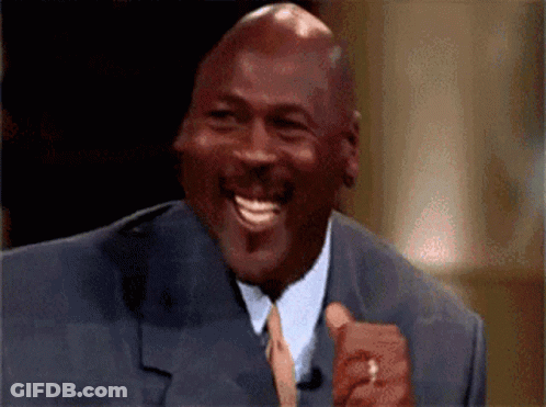 A Bald Man In A Suit And Tie Is Laughing GIF