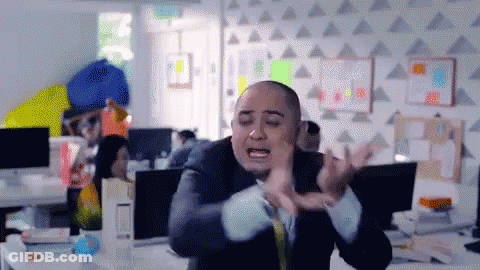 A Bald Man In A Suit And Tie Is Making A Funny Face GIF