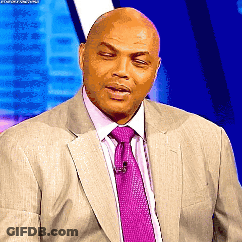 A Bald Man In A Suit And Tie Is Making A Funny Face .. GIF