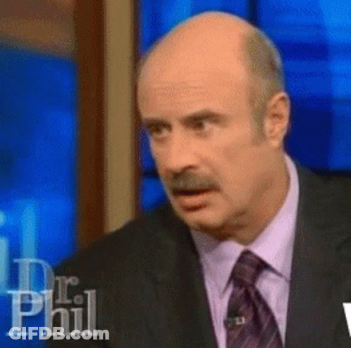 A Bald Man In A Suit And Tie Is On A Dr Phil Show GIF