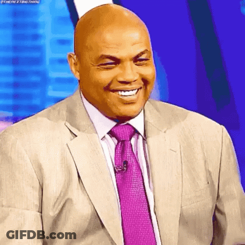 A Bald Man In A Suit And Tie Is Smiling With His Eyes Closed GIF