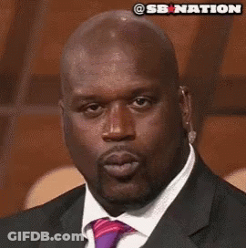 A Bald Man In A Suit And Tie With A Sb Nation Logo Above His Head GIF