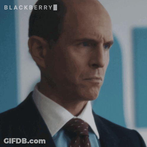 A Bald Man In A Suit And Tie With The Word Blackberry On The Bottom GIF