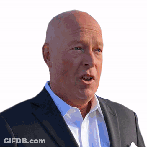 A Bald Man In A Suit And White Shirt Is Speaking GIF
