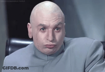 A Bald Man In A Suit Is Making A Face . GIF