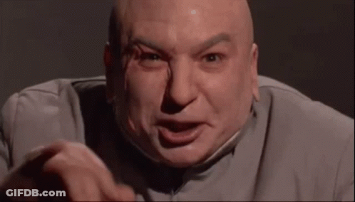 A Bald Man In A Suit Is Making A Funny Face And Pointing At The Camera . GIF