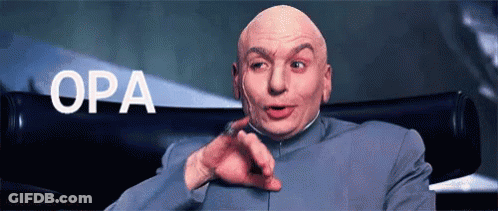 A Bald Man In A Suit Is Pointing At The Camera With The Word Opa Behind Him GIF