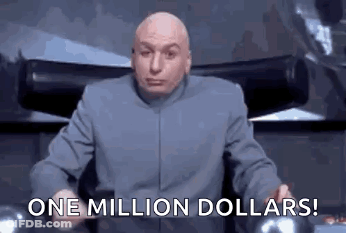 A Bald Man In A Suit Is Sitting In A Chair And Holding A Cell Phone . GIF