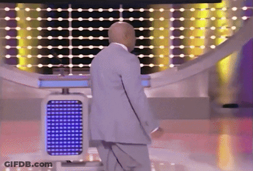 A Bald Man In A Suit Is Standing In Front Of A Blue Lighted Podium GIF