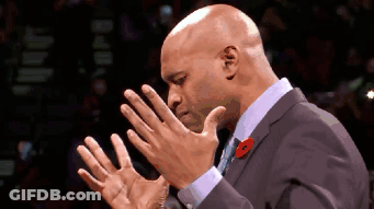 A Bald Man In A Suit With A Poppy On His Lapel Is Clapping His Hands GIF