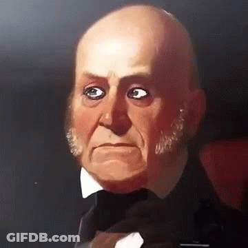 A Bald Man In A Tuxedo And Bow Tie Is Looking At The Camera GIF