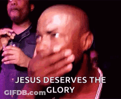 A Bald Man Is Covering His Mouth With His Hand And The Words `` Jesus Deserves The Glory '' Are Behind Him . GIF