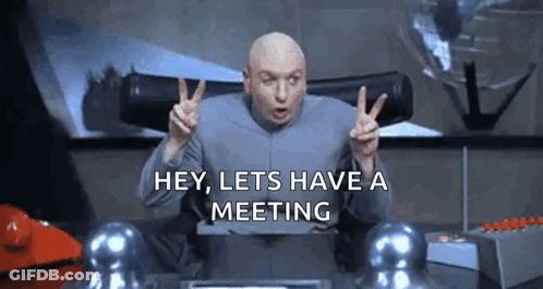 A Bald Man Is Giving A Peace Sign And Saying `` Hey , Lets Have A Meeting '' GIF