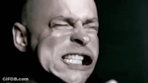A Bald Man Is Making A Funny Face With His Eyes Closed . GIF
