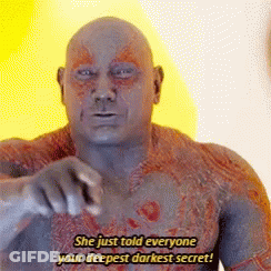A Bald Man Is Pointing At The Camera And Says `` She Just Told Everyone Your Deepest Darkest Secret ! '' GIF