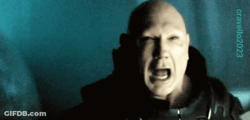 A Bald Man Is Screaming In A Dark Room With A Blue Background And A Watermark That Says Cavallo023 GIF