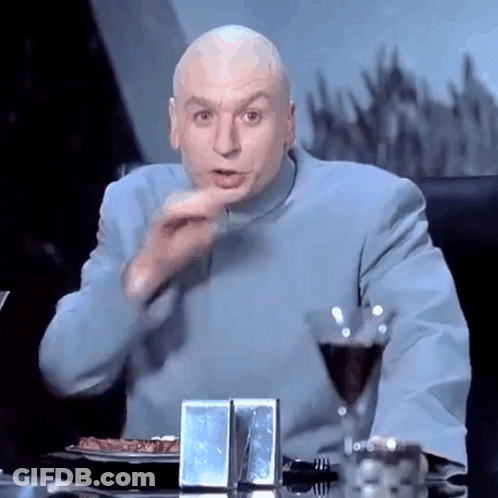 A Bald Man Is Sitting At A Table With A Glass Of Wine And A Plate Of Food GIF