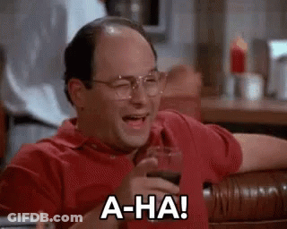 A Bald Man Is Sitting At A Table With A Glass Of Wine And Laughing . GIF