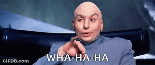A Bald Man Is Sitting In A Chair Making A Funny Face And Pointing At The Camera . GIF