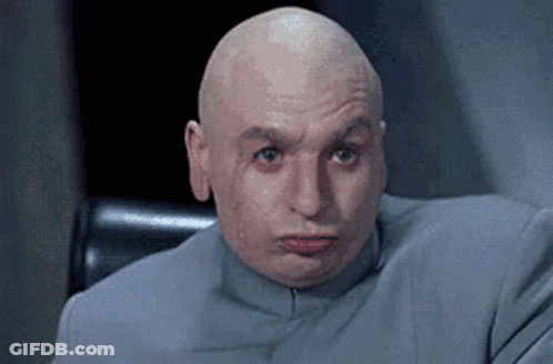 A Bald Man Is Sitting In A Chair With His Eyes Closed . GIF