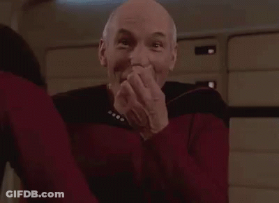 A Bald Man Is Sitting In A Chair With The Words `` Got Ya '' Written On His Face . GIF