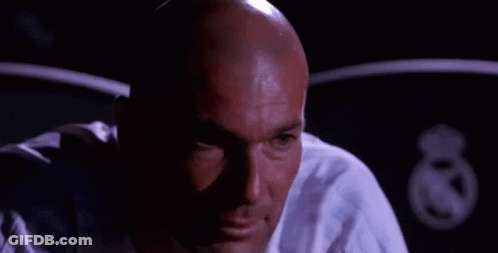 A Bald Man Is Sitting In A Dark Room With The Words `` C ' Est Les Émotions '' Written On The Screen . GIF