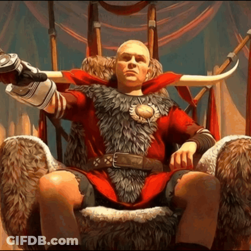 A Bald Man Is Sitting On A Throne Wearing A Red Fur Coat GIF