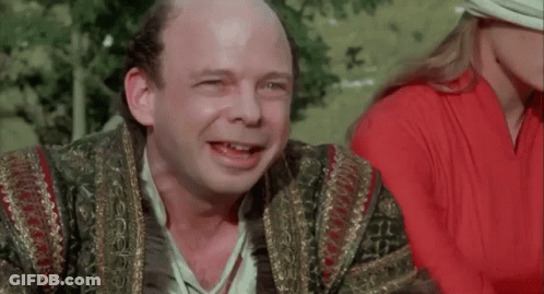 A Bald Man Is Smiling With The Words " You Fell Victim " Behind Him GIF