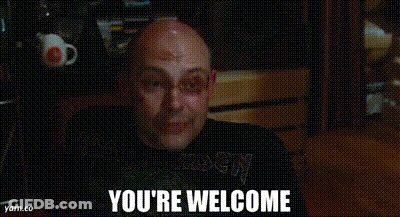 A Bald Man Is Smiling With The Words `` You 'Re Welcome '' Written Below Him . GIF