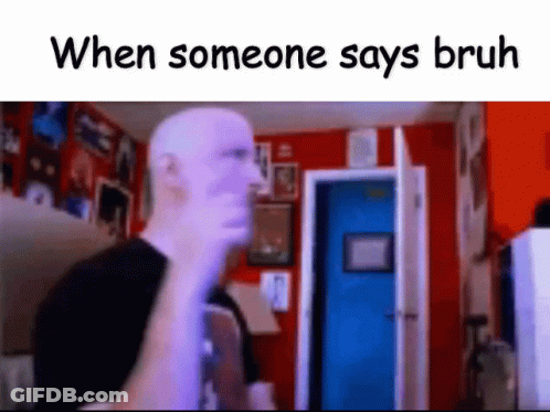 A Bald Man Is Standing In A Room With A Blue Door And A Red Wall . GIF