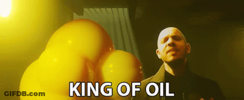 A Bald Man Is Standing In Front Of A Bunch Of Yellow Balloons With The Words King Of Oil Above Him GIF