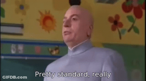 A Bald Man Is Standing In Front Of A Chalkboard In A Classroom And Says `` Pretty Standard , Really '' . GIF