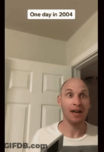 Bald Man Standing In Front Of Door With 2004 Sticker GIF