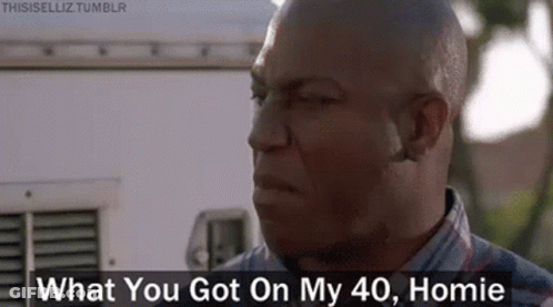 A Bald Man Is Standing In Front Of A White Van And Talking To Someone . GIF