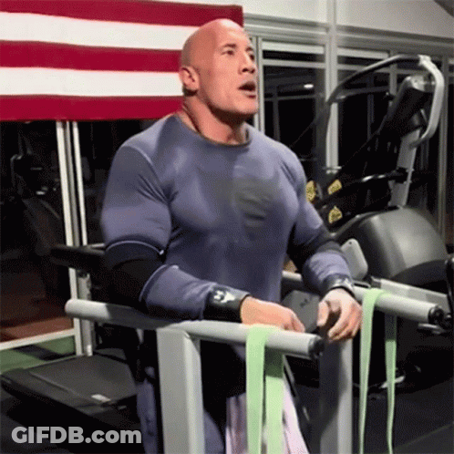 A Bald Man Is Standing On A Treadmill Wearing A Shirt That Says Superman GIF