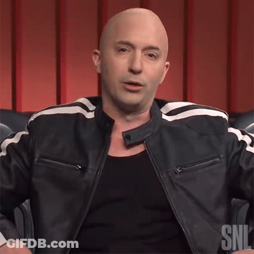 A Bald Man Is Wearing A Black Shirt And A Black Leather Jacket With A Snl Logo On It GIF
