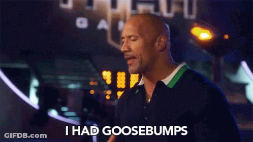 A Bald Man Says I Had Goosebumps In Front Of A Sign That Says Gam GIF