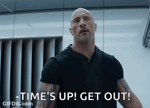 A Bald Man Says Time 'S Up Get Out In A Movie Scene GIF
