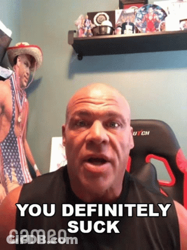 A Bald Man Says " You Definitely Suck " In Front Of A Picture Of A Man In A Bikini GIF