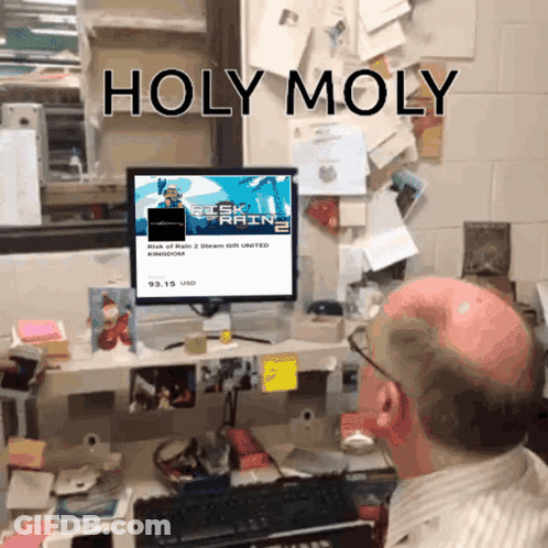 A Bald Man Sits At A Desk Looking At A Computer Screen That Says Holy Moly On It GIF