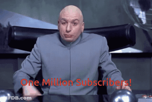 A Bald Man Sitting At A Desk With The Words " One Million Subscribers " On The Bottom GIF