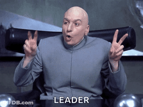 A Bald Man Sitting In A Chair With The Word Leader Written On The Bottom GIF