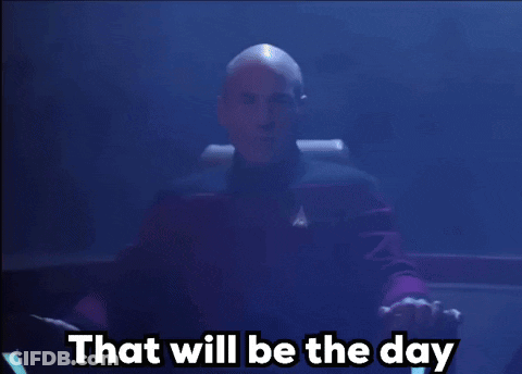 A Bald Man Sitting In A Chair With The Words That Will Be The Day Behind Him GIF