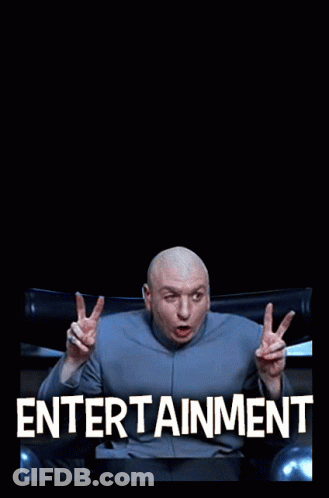 A Bald Man Sitting In Front Of The Hollywood Sign GIF