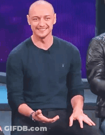 A Bald Man Wearing A Black Polo Shirt Is Clapping GIF