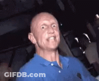 A Bald Man Wearing A Blue Shirt Making A Funny Face GIF
