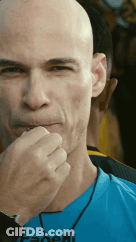 A Bald Man Wearing A Blue Shirt That Says Fadeli On It GIF