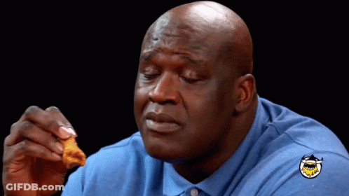 A Bald Man Wearing A Blue Shirt With A Shark On It GIF