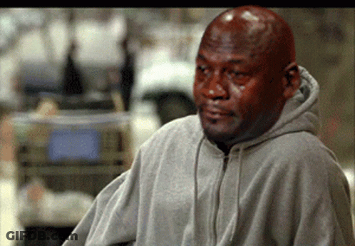 A Bald Man Wearing A Gray Hoodie Looks Sad GIF